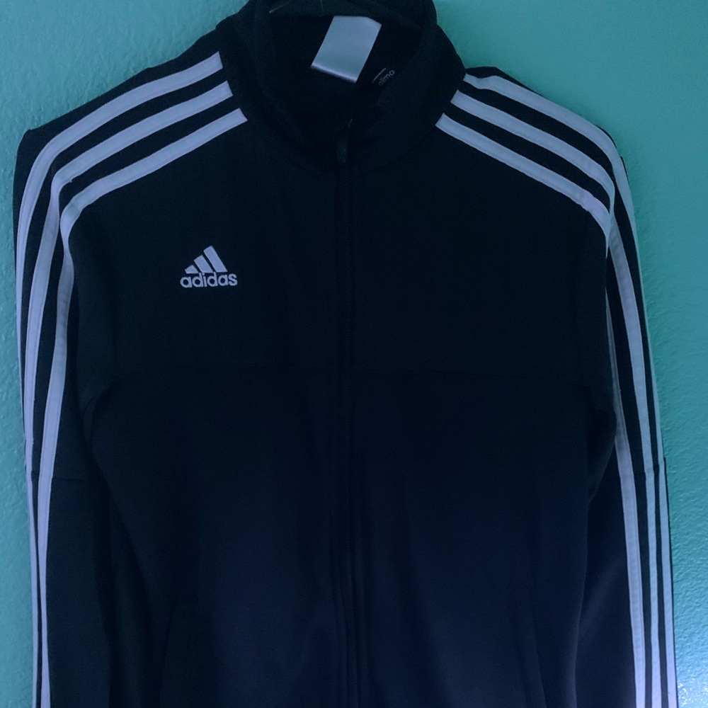It is a black and white adidas jacket.